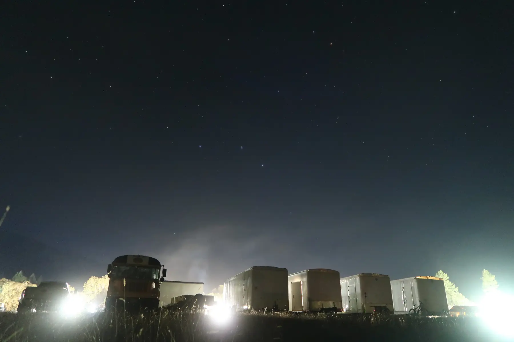 An Evergreen base camp lit by its own light towers at night