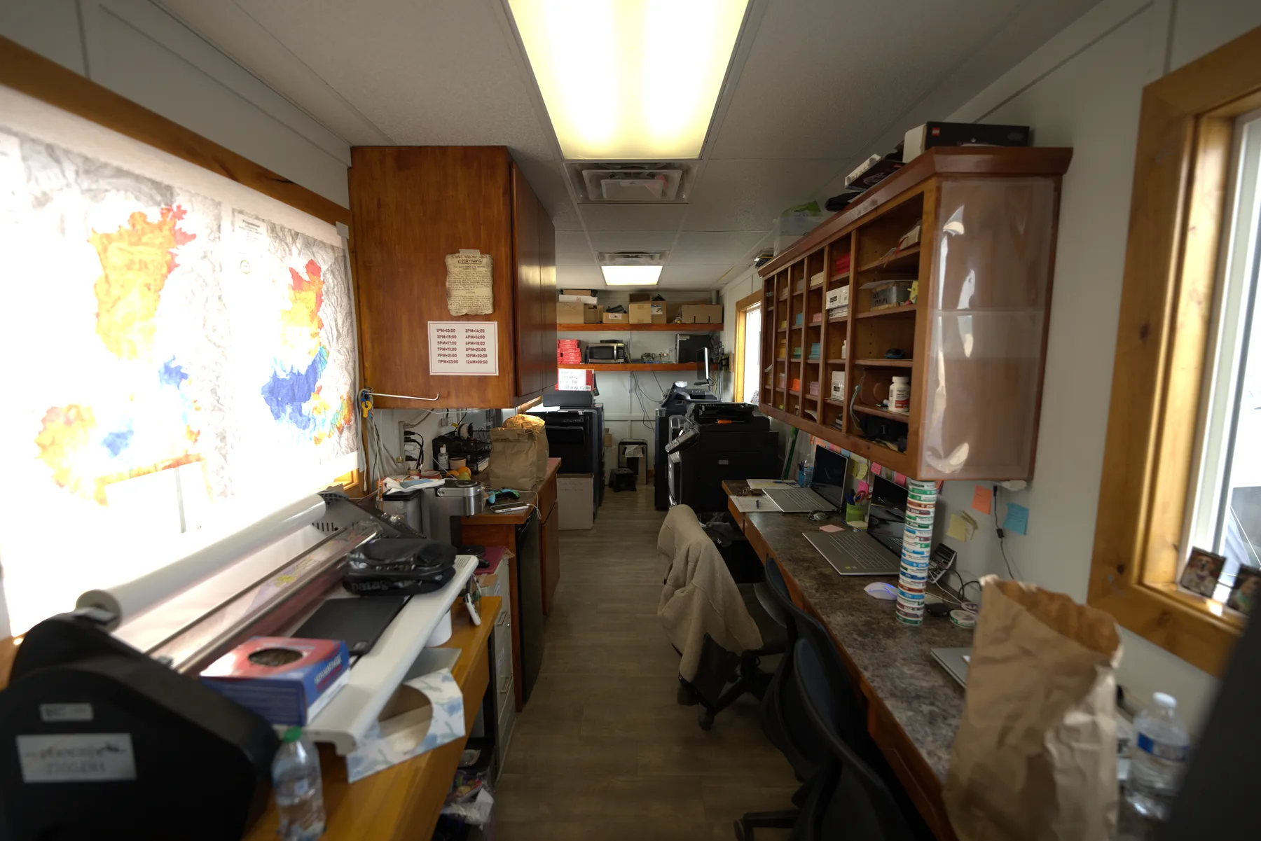 Inside the Evergreen clerical support trailer with workstations and incident maps on the wall