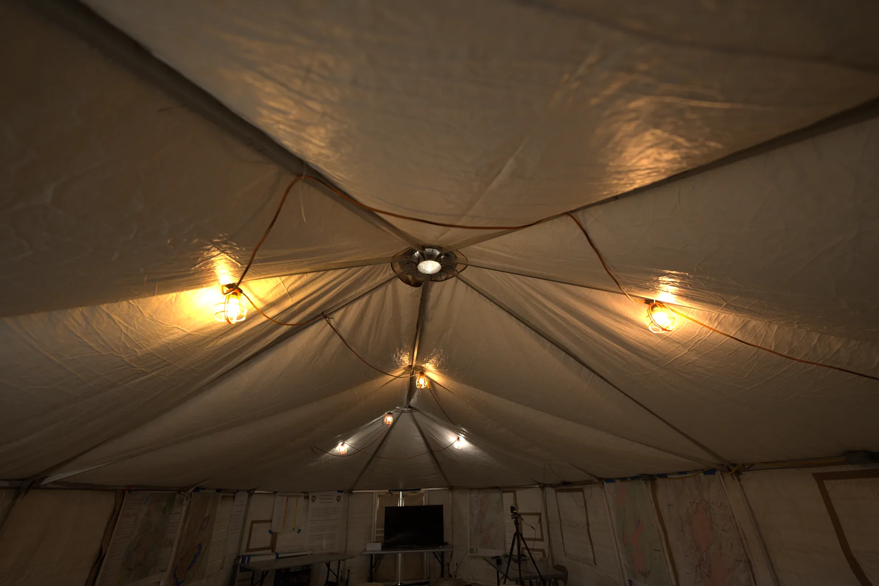 Looking up into the dome ceiling of an Evergreen yurt lit from inside
