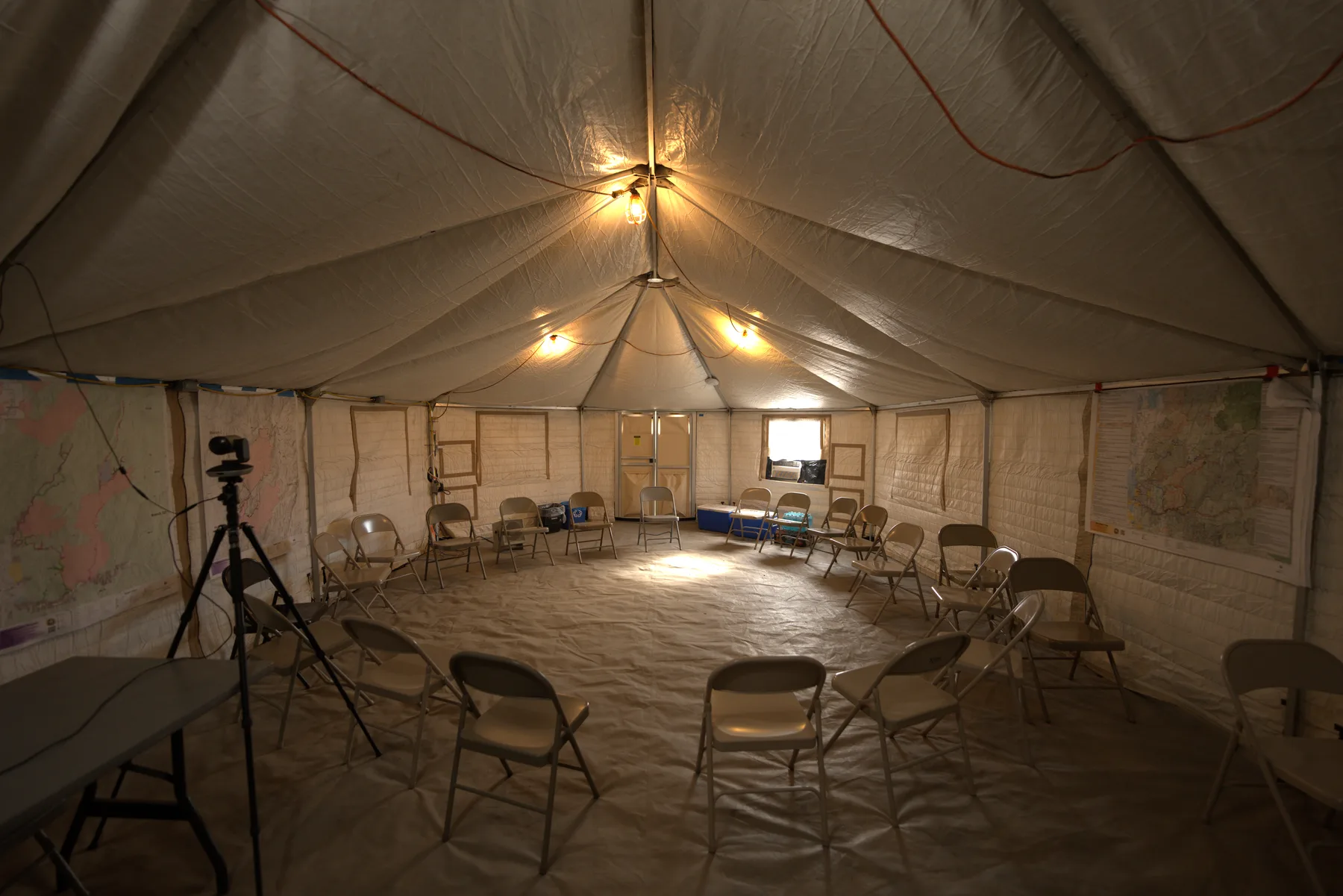 The inside of an Evergreen yurt set up with chairs as a briefing space